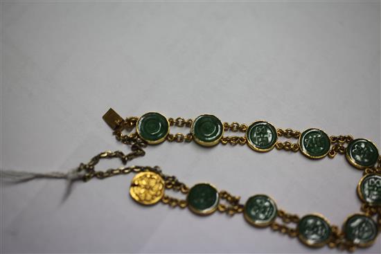 A Chinese high carat double chain link gold and jadeite bracelet, 6.5in.